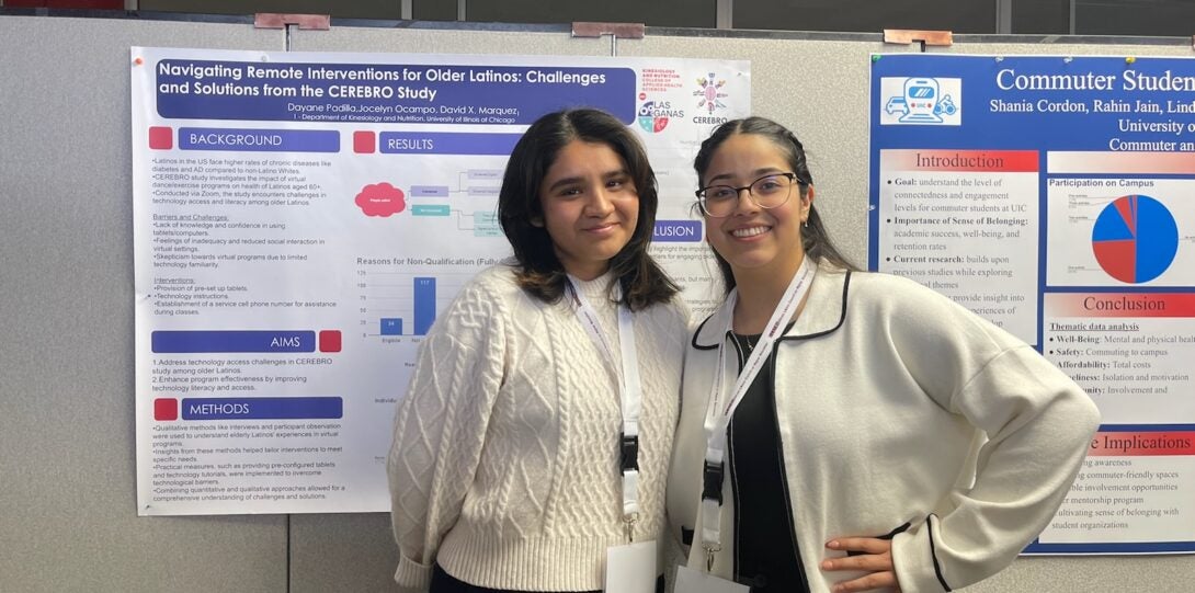 two women standing in front of poster